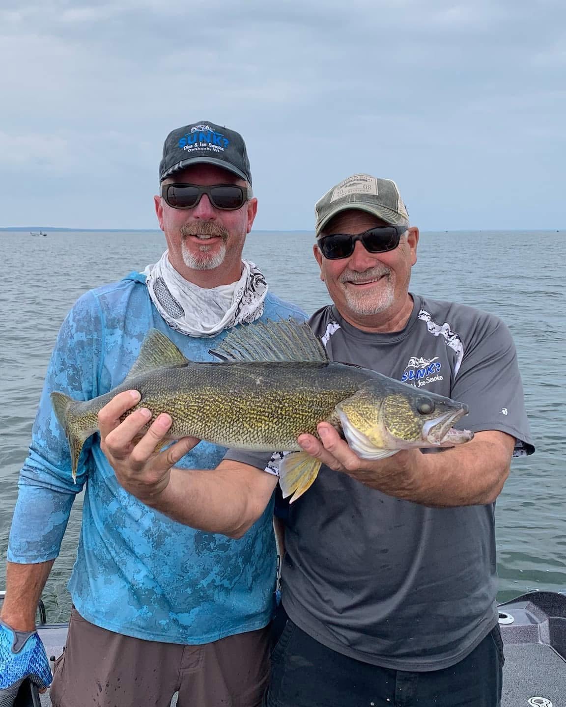Captain Chad Burns and Donnie from Sunk Dive and Ice Service holding a large walleye